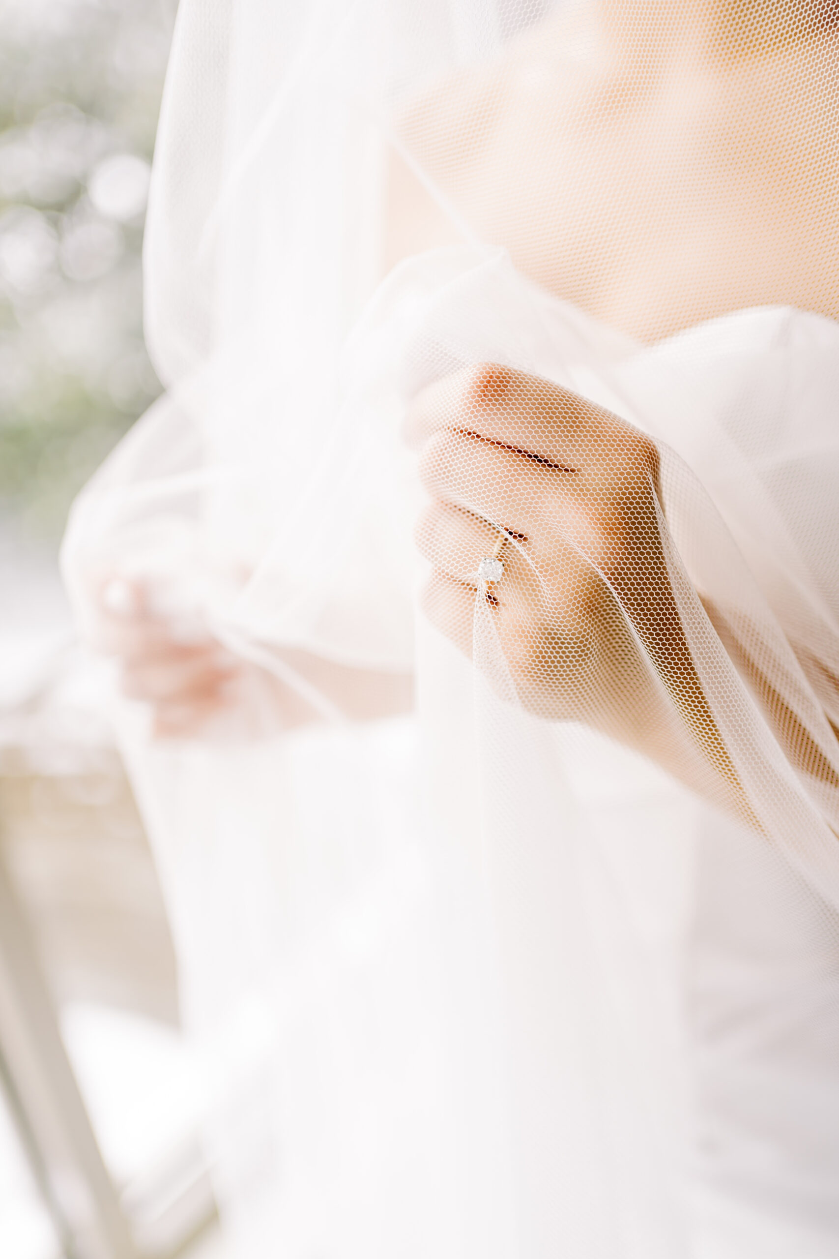 Bride solitaire wedding ring under veil