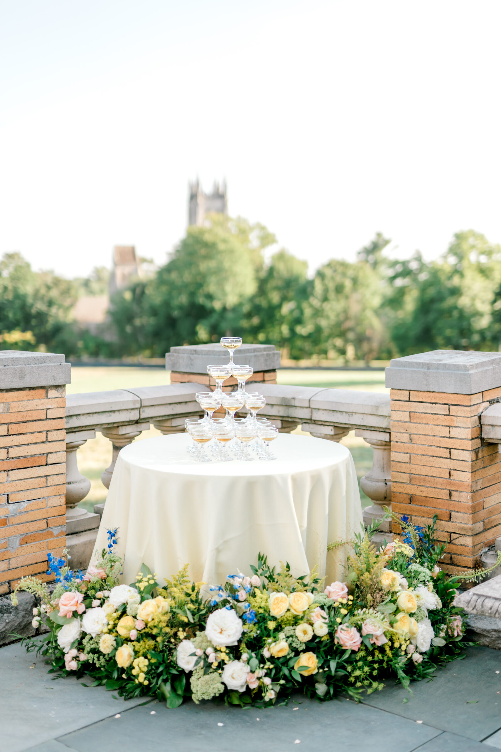a champagne tower on yellow table cloth with pink yellow and blue florals