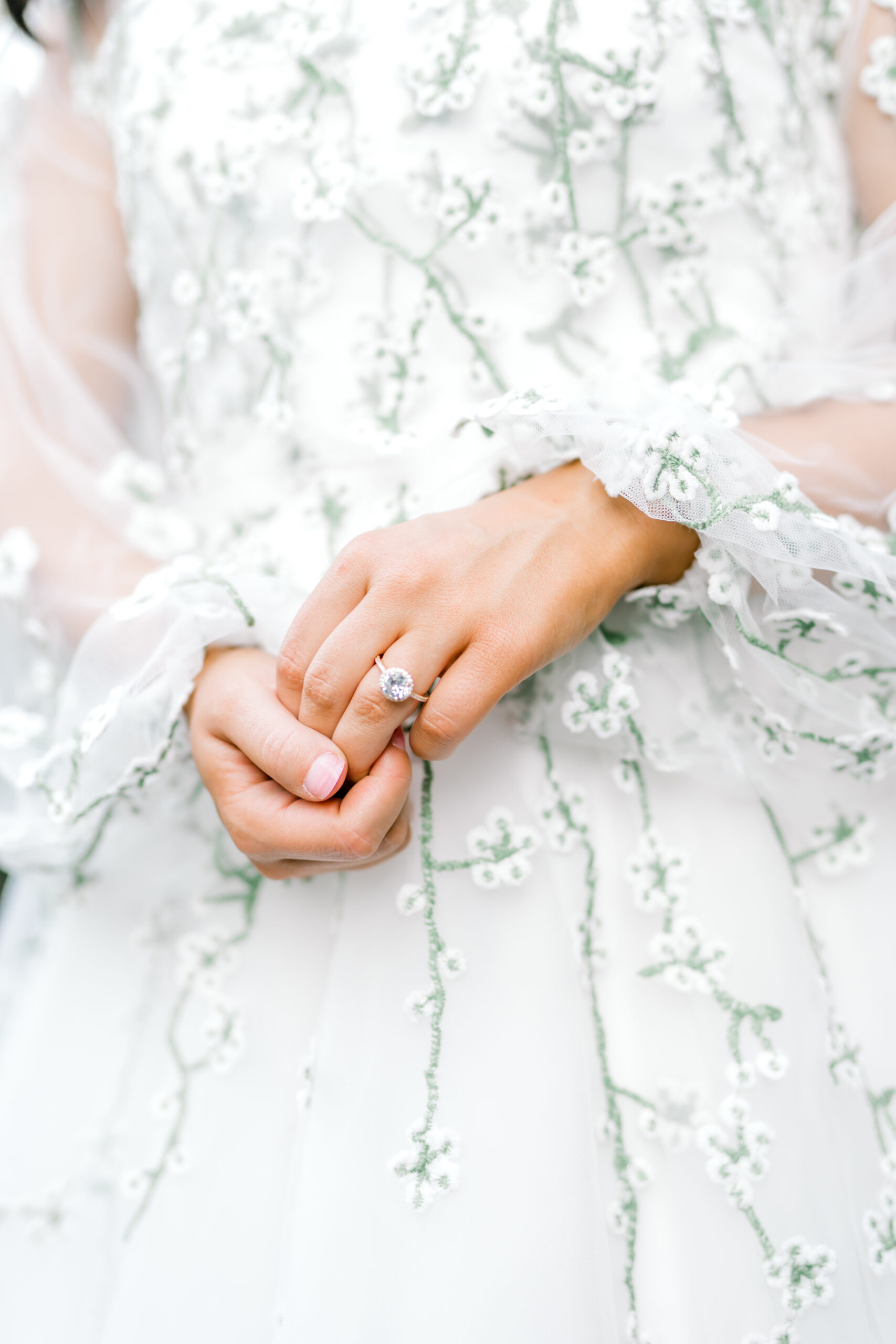 Bride with her hands clasped showing her wedding ring