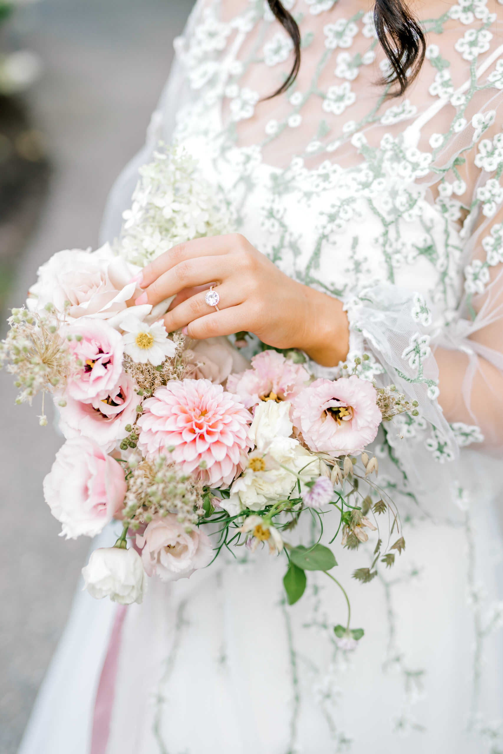bride touches the flowers in her bouquet