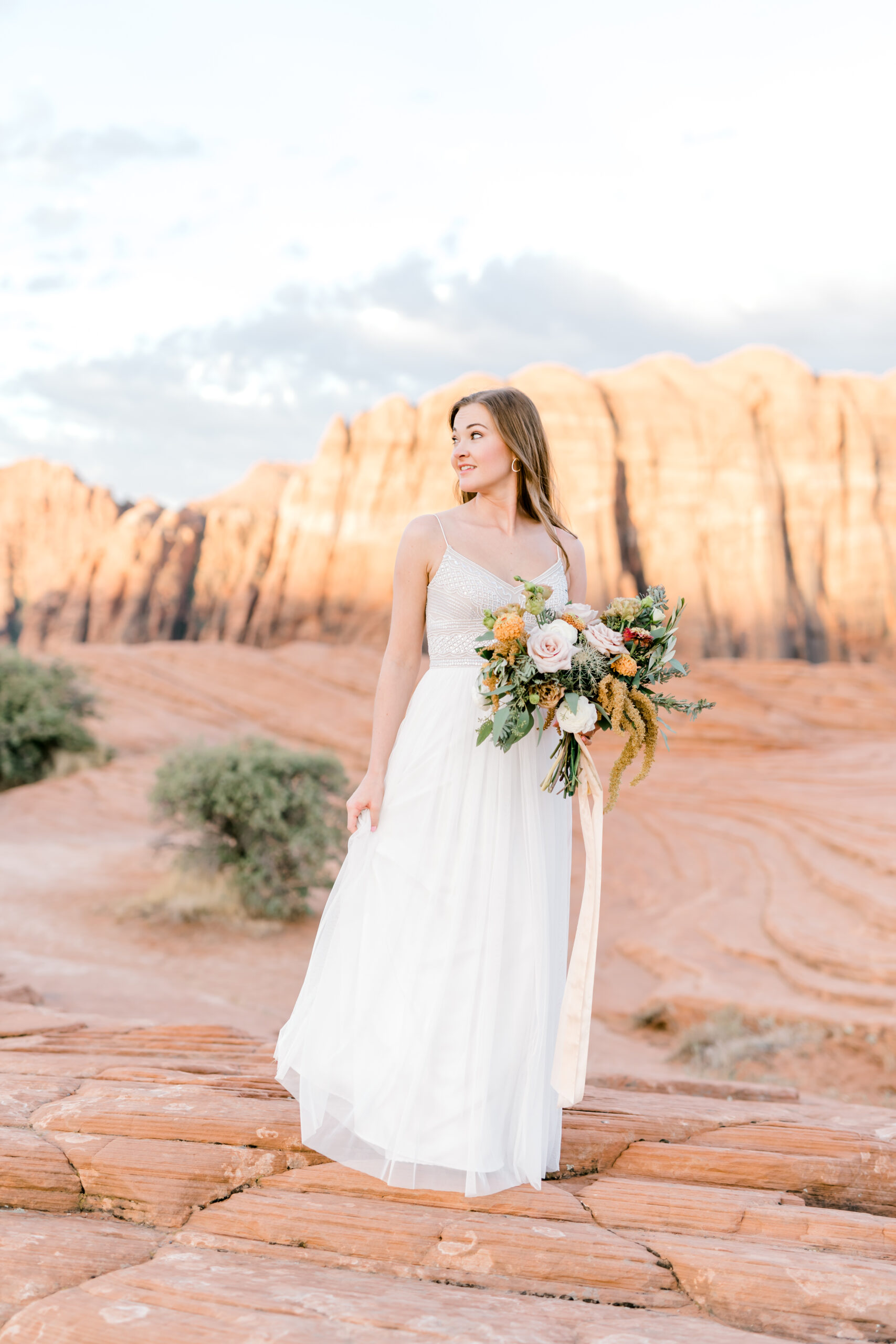 Bride posing in front of large mountain